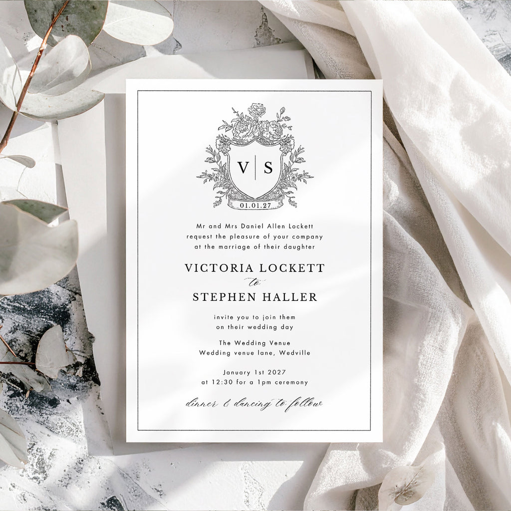wedding invite with a black and white wedding crest