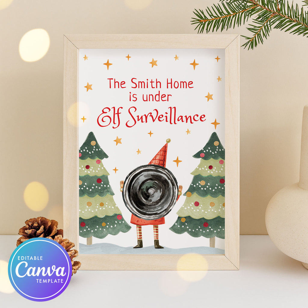 Framed Christmas-themed print with 'Elf Surveillance' text and camera illustration.