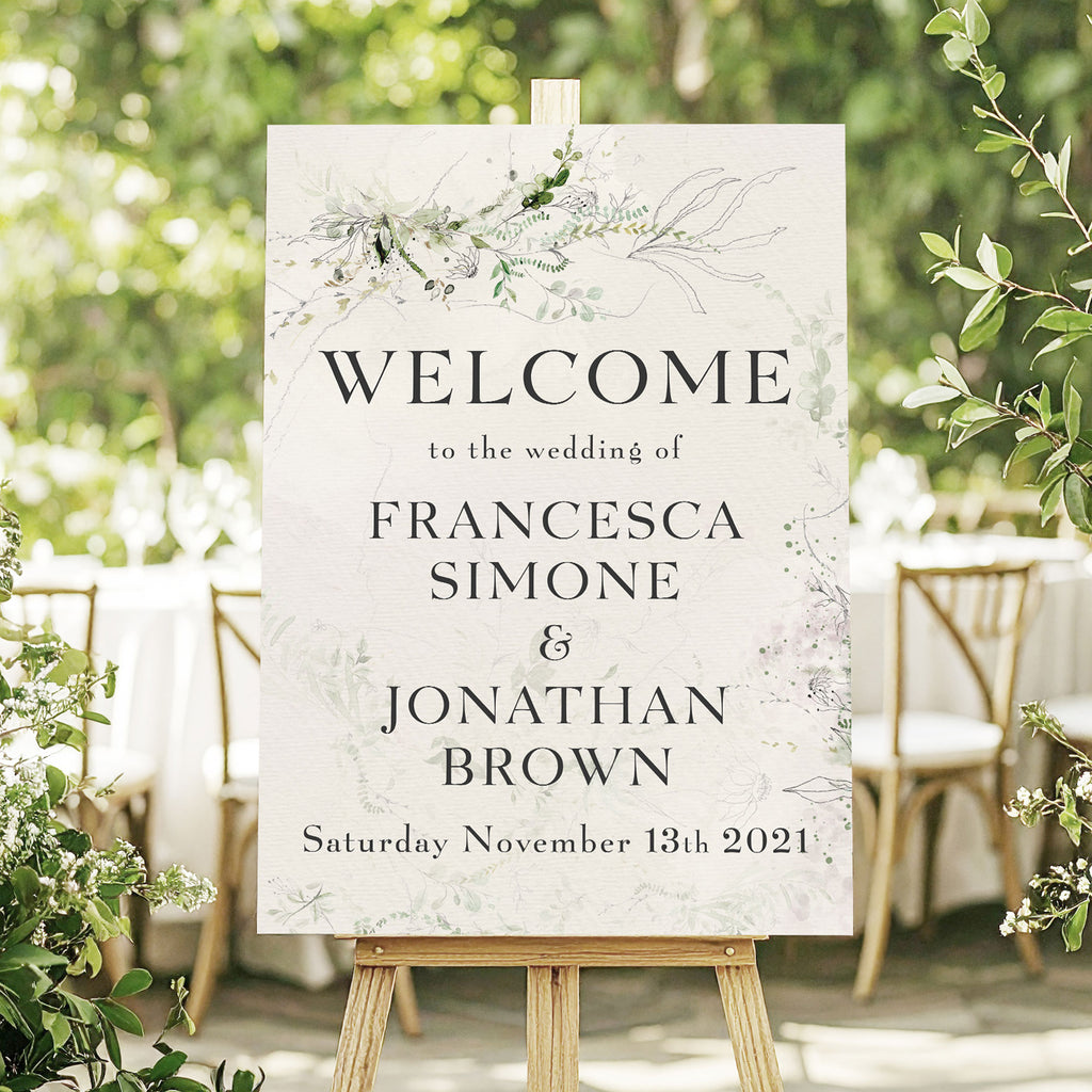 wedding welcome sign with delicate green foliage