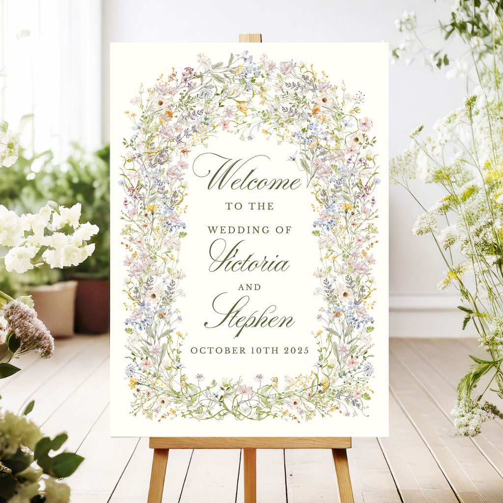 wedding welcome sign with a pastel wildflowers arch